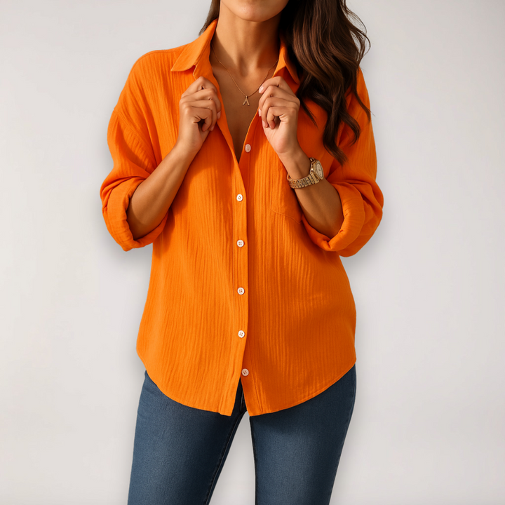 Pink women's button-front blouse with roll-up sleeves, a stylish and lightweight top for everyday elegance.