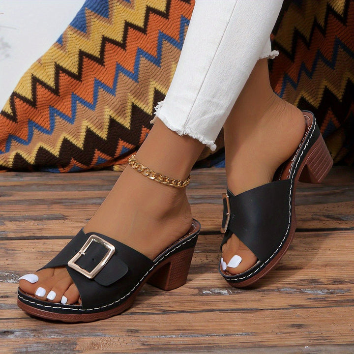 Close-up of chic women's open-toe flats, highlighting material and comfortable design.