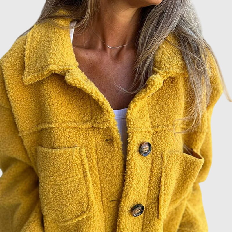 Close-up of the stylish button closure & spacious pockets on this elegant women's fall jacket.