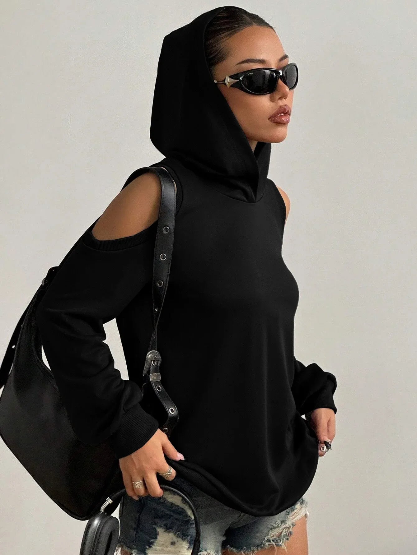 Versatile black off-shoulder women's hoodie, a stylish cutout top for comfortable everyday fashion.