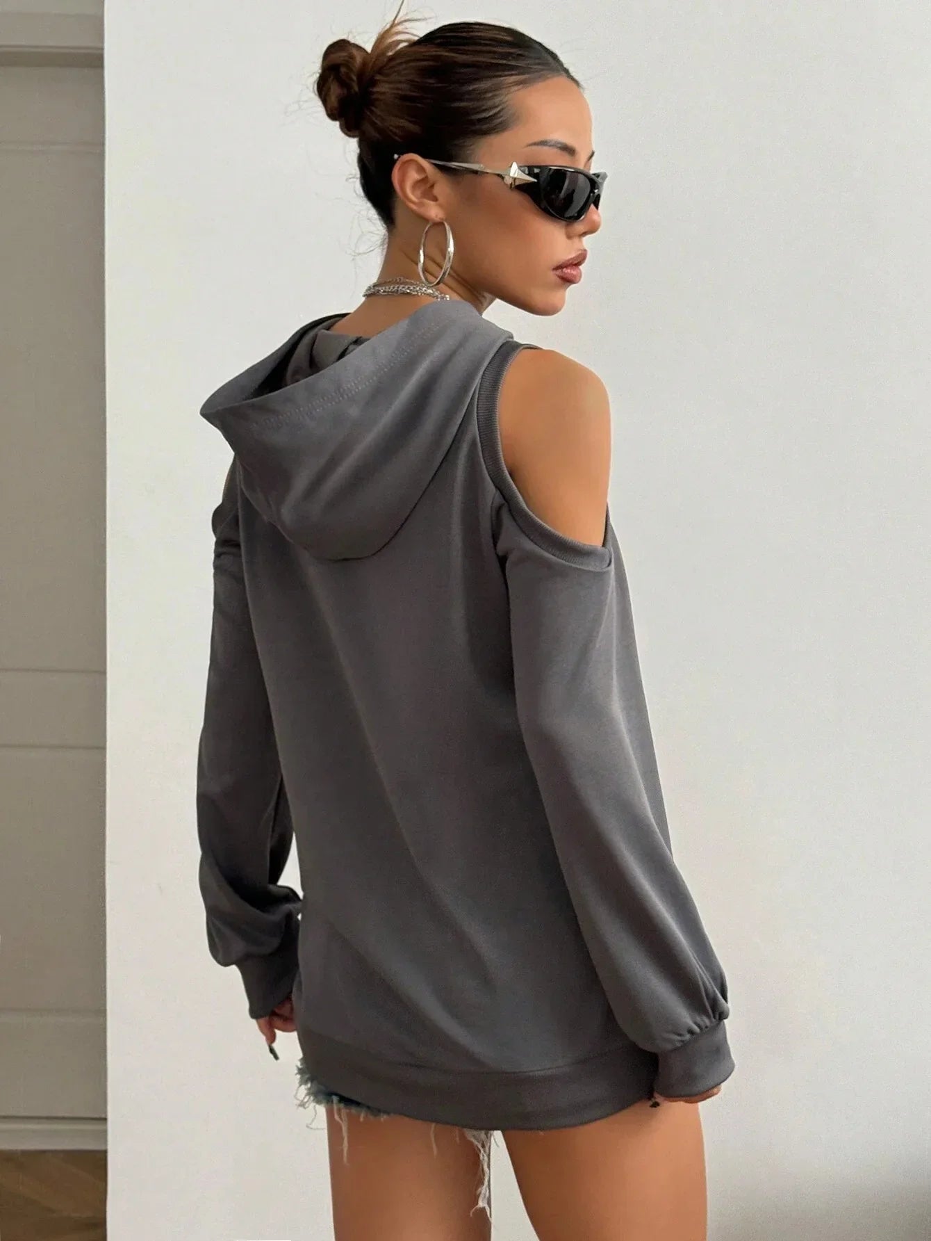 Black off-shoulder women's hoodie, a relaxed fit cutout sweatshirt for modern everyday style.