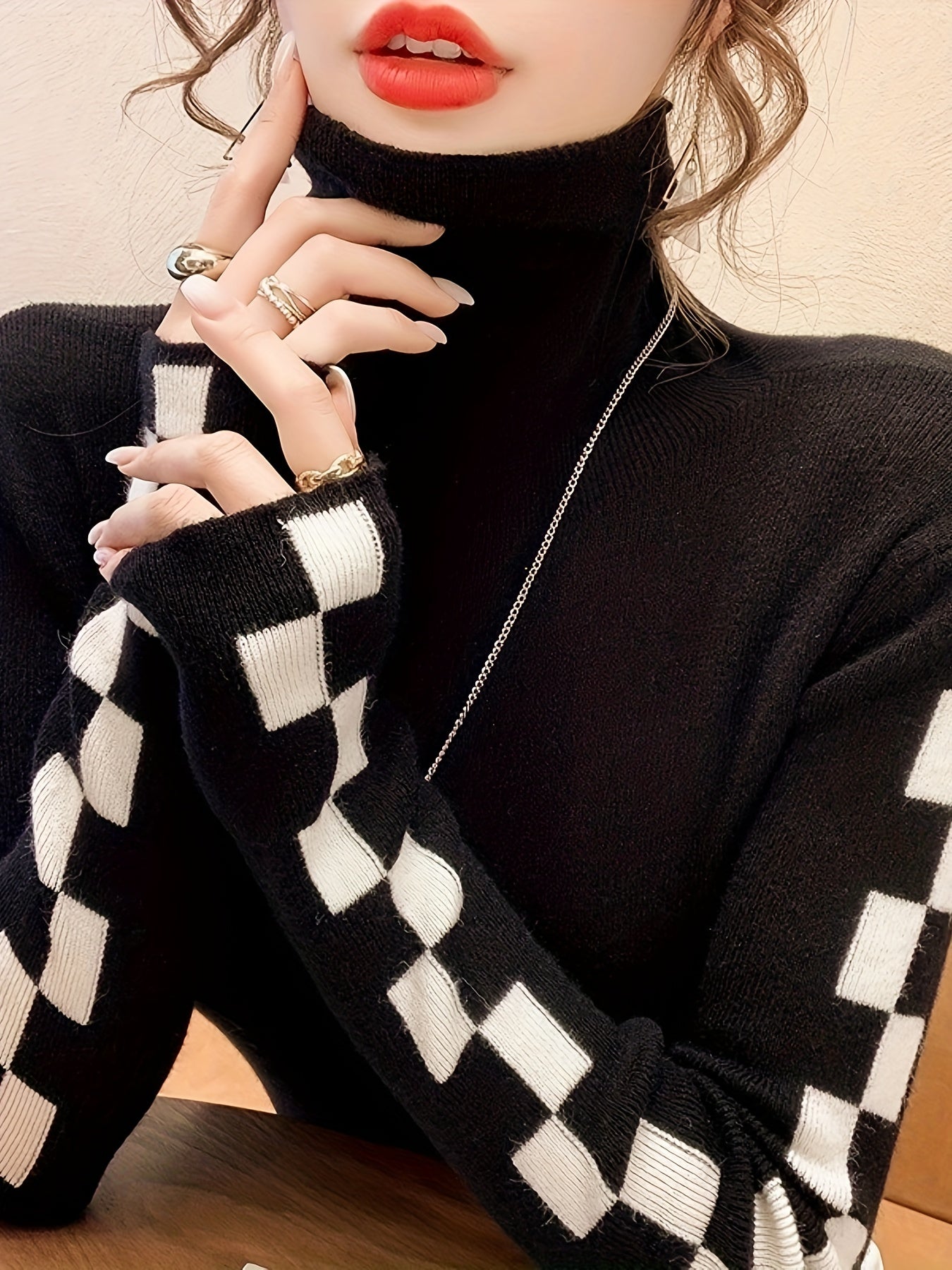 Chic women's high-neck sweater with eye-catching check sleeves. Perfect for versatile winter fashion.