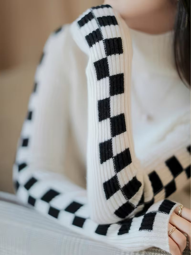 Trendy women's statement sleeve high-neck sweater with elegant check pattern for winter style.