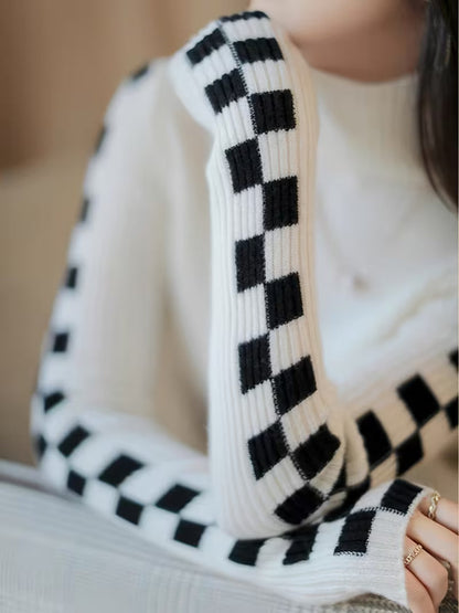 Trendy women's statement sleeve high-neck sweater with elegant check pattern for winter style.