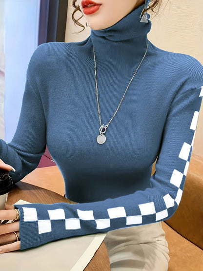 Elegant women's turtleneck sweater featuring unique check pattern sleeves. Stylish winter casual wear.