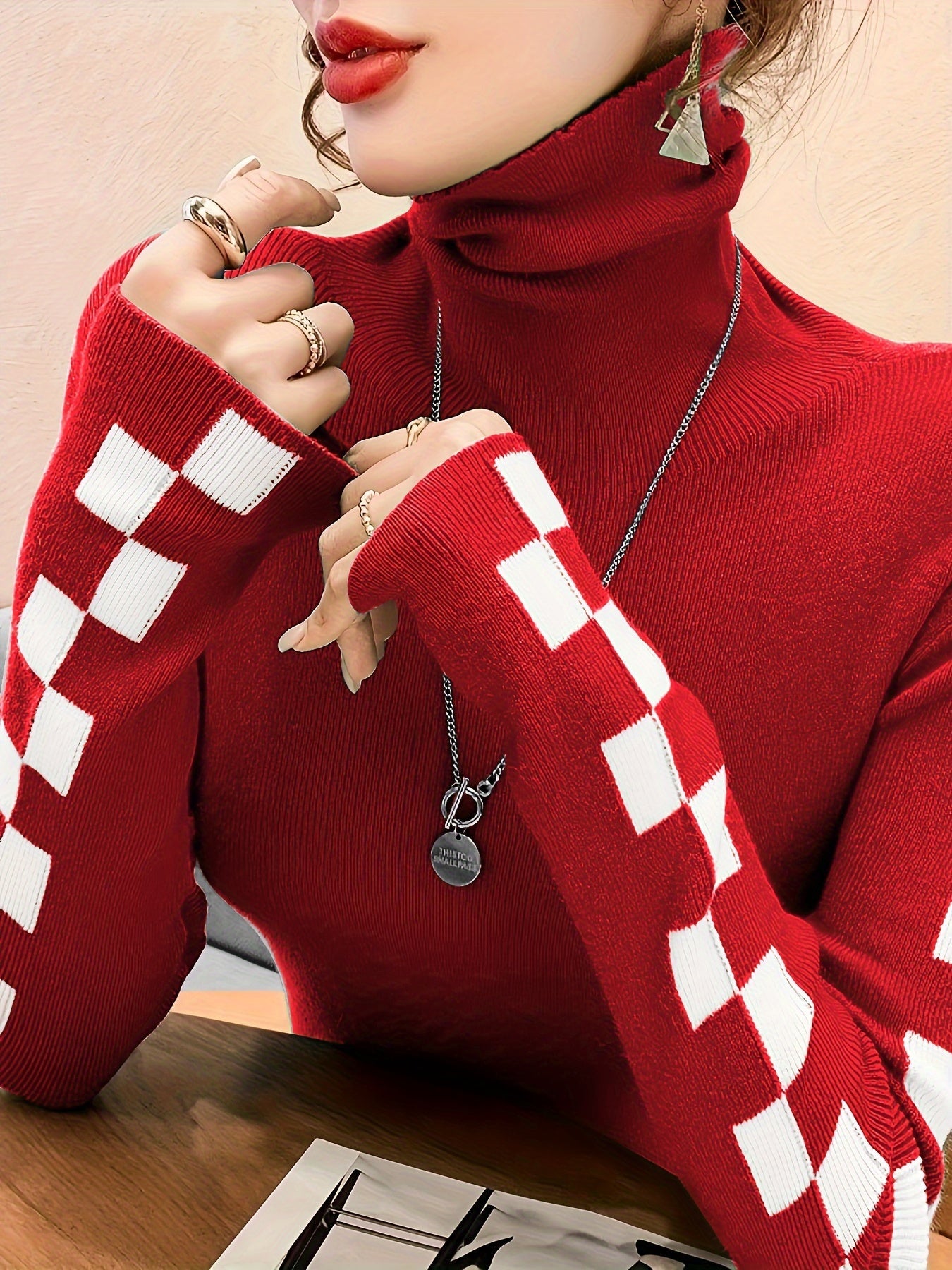 Cozy women's high-neck sweater with fashionable check sleeves, ideal for winter style & layering.