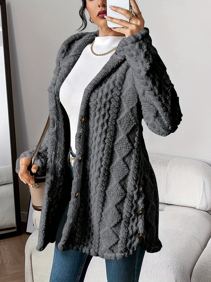 Fashionable women's long button-up coat with hood, versatile for various occasions.