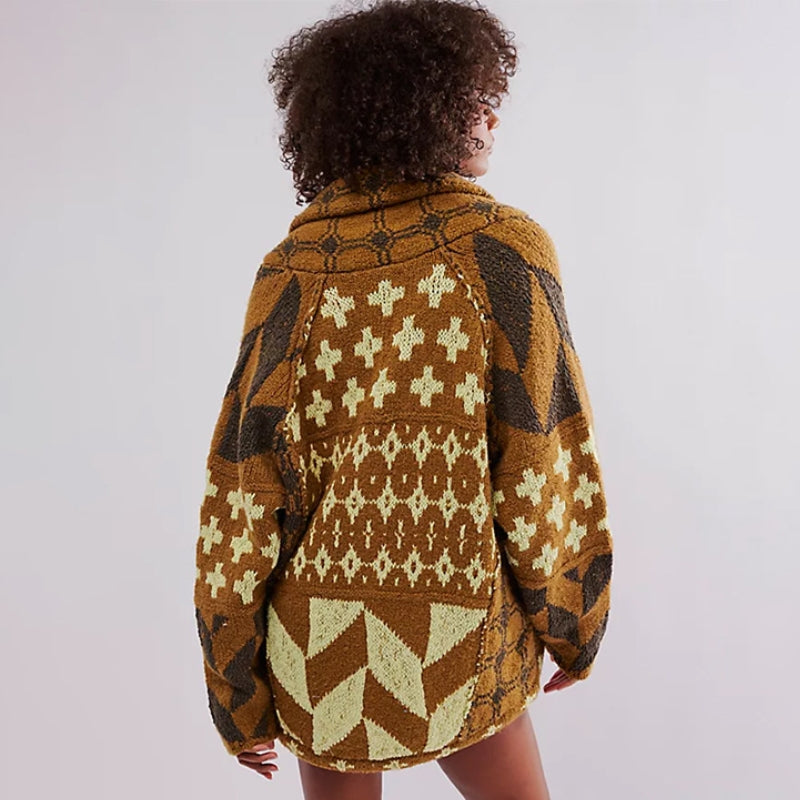 Woman wearing an oversized geometric knit cardigan, trendy & warm for a chic casual look.