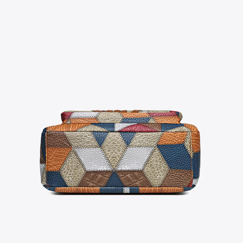 Back view of women's stylish patchwork handbag, showcasing smooth vegan leather and secure zipper.