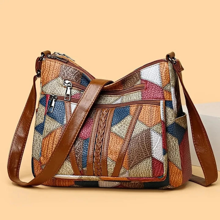 Trendy women's geometric patchwork shoulder bag, vibrant multi-color design, chic fashion statement.