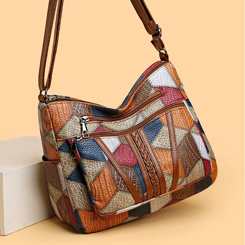Detailed close-up of women's patchwork vegan leather handbag, showcasing unique geometric patterns.