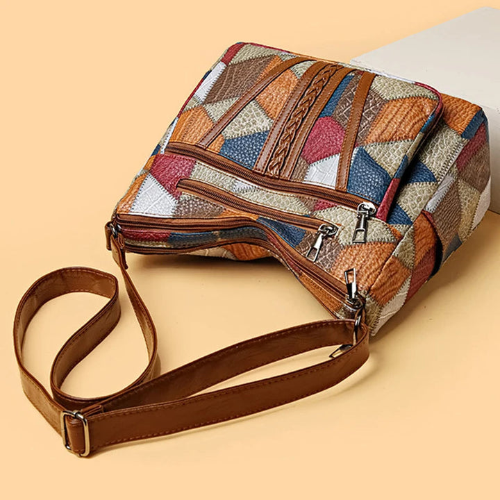 Woman carrying a stylish patchwork shoulder bag, modern vegan leather design, versatile fashion accessory.