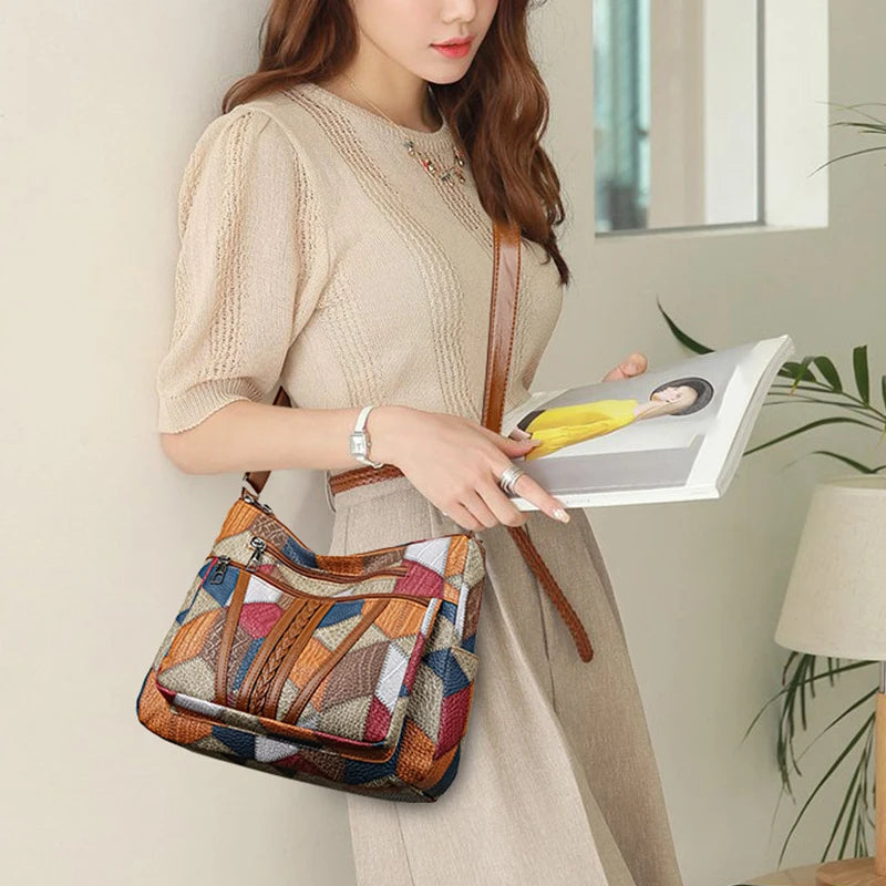 Front view of women's vibrant patchwork handbag, quality vegan leather, spacious main compartment.