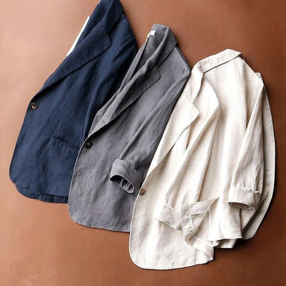 Close-up of lightweight women's relaxed blazer fabric, showing versatile neutral texture. Great for summer fashion.