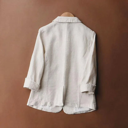 Neutral women's relaxed fit blazer laid flat. A stylish and versatile piece for summer office wear or casual chic.