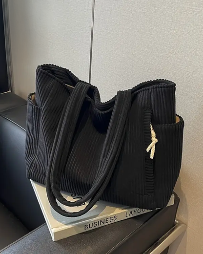 Ribbed women's tote bag with distinctive cord accents, a modern and casual everyday shoulder bag.