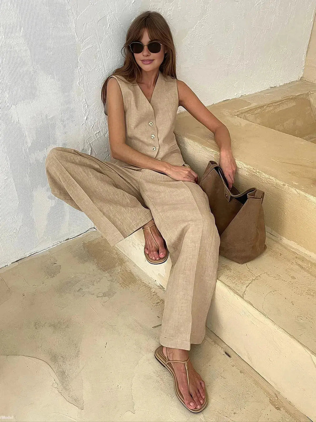 Chic women's two-piece summer outfit: tailored waistcoat & relaxed fit wide-leg trousers. Versatile style.