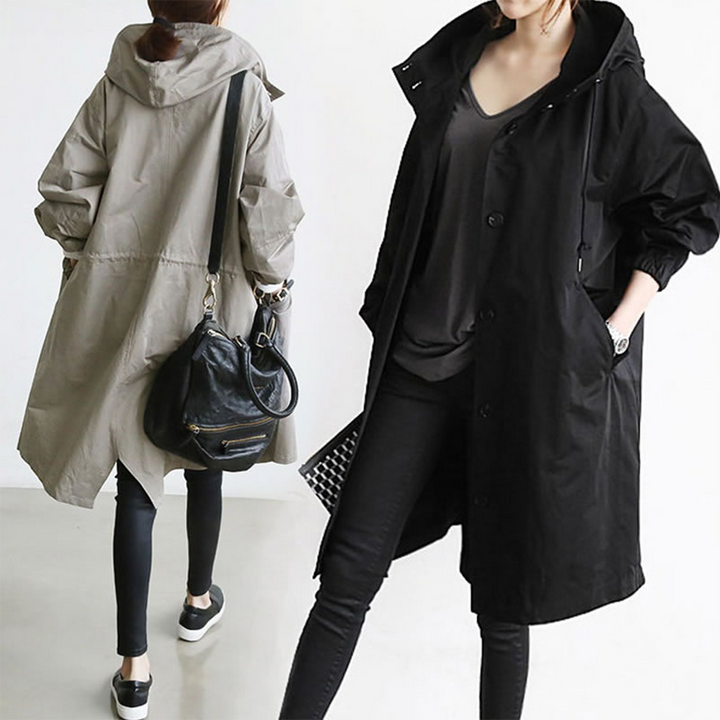 Chic women's long waterproof jacket, a stylish trench coat for effective outdoor rain protection.