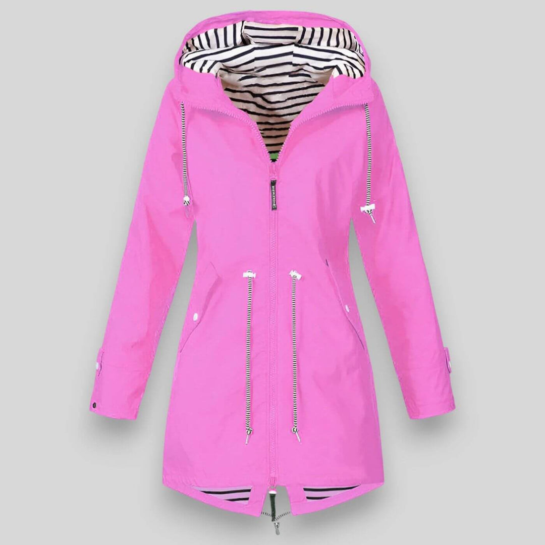 Model wearing a lightweight women's waterproof jacket outdoors, ready for hiking or urban adventures.
