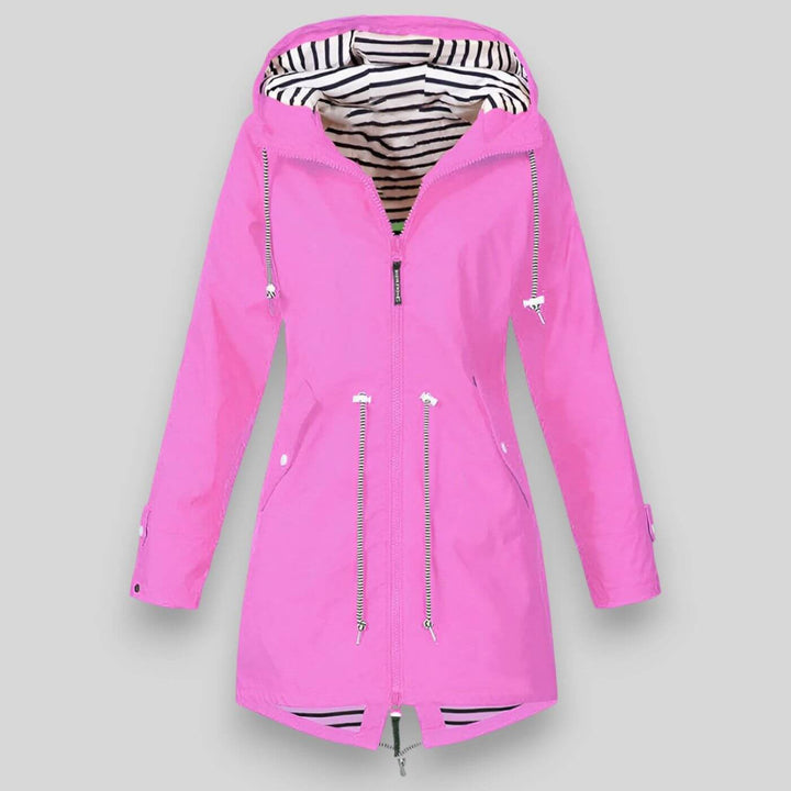 Model wearing a lightweight women's waterproof jacket outdoors, ready for hiking or urban adventures.