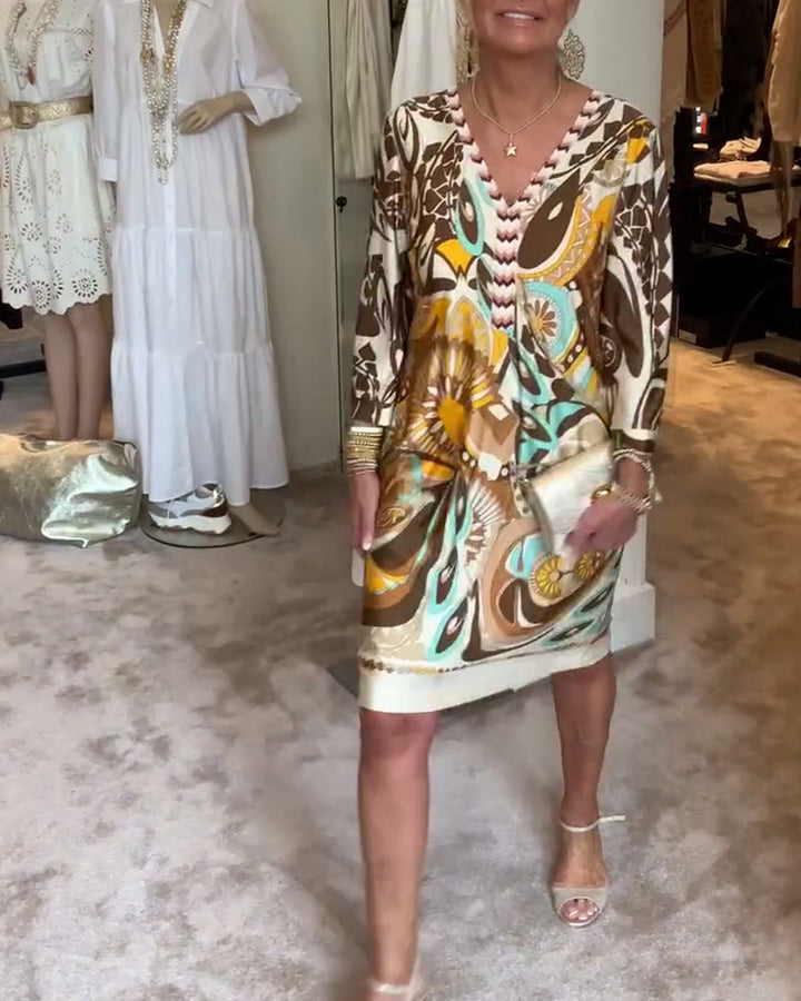 Bohemian V-neck tunic dress featuring a vibrant sunburst artistic print, ideal for everyday style.
