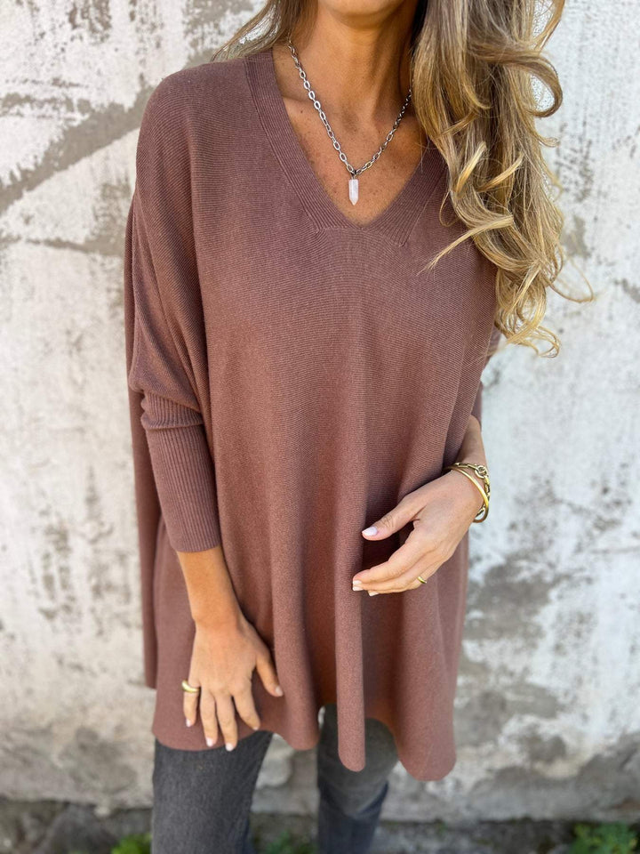 Relaxed fit women's swing tunic sweater with V-neck and batwing sleeves. Comfortable everyday pullover.