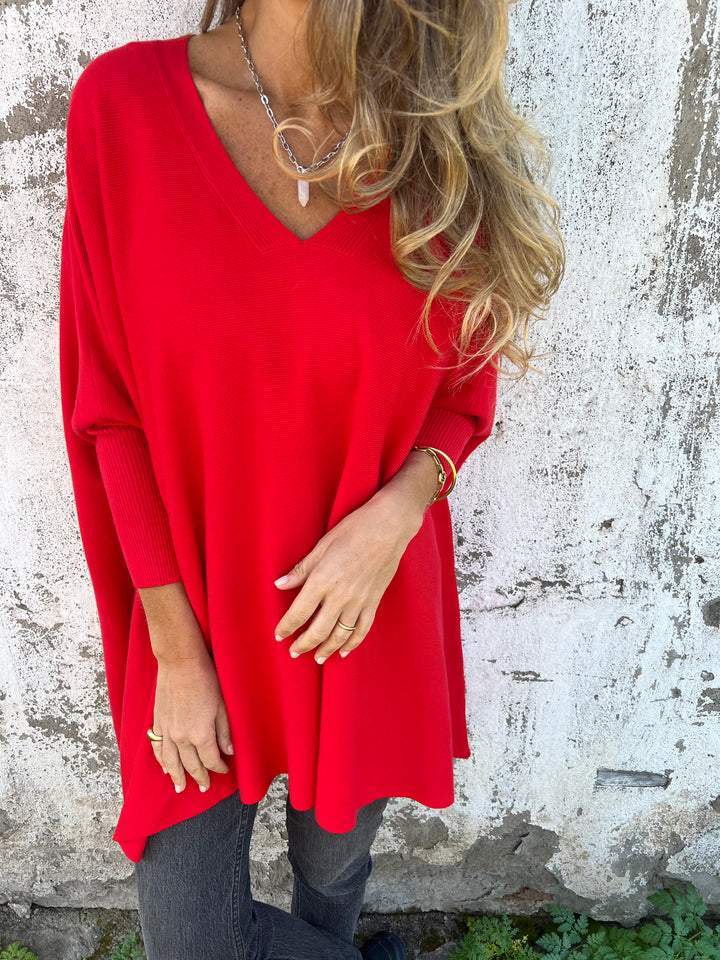 Comfortable women's V-neck swing tunic pullover sweater. Relaxed batwing long sleeve design for versatile wear.