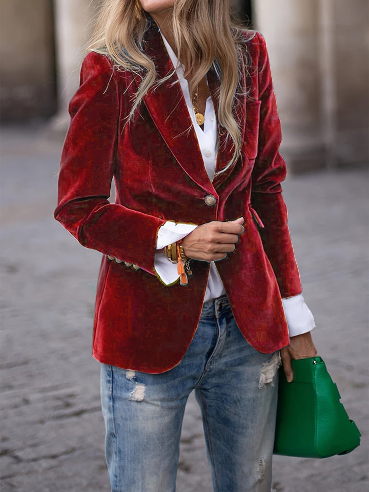 Women's tailored velvet blazer with elegant gold buttons, perfect for formal or business attire.