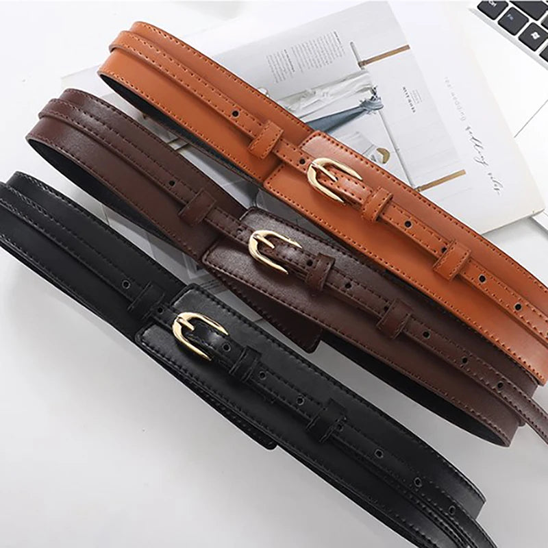 Dress up your outfit with this women's adjustable brown dual-strap vegan leather waist belt.