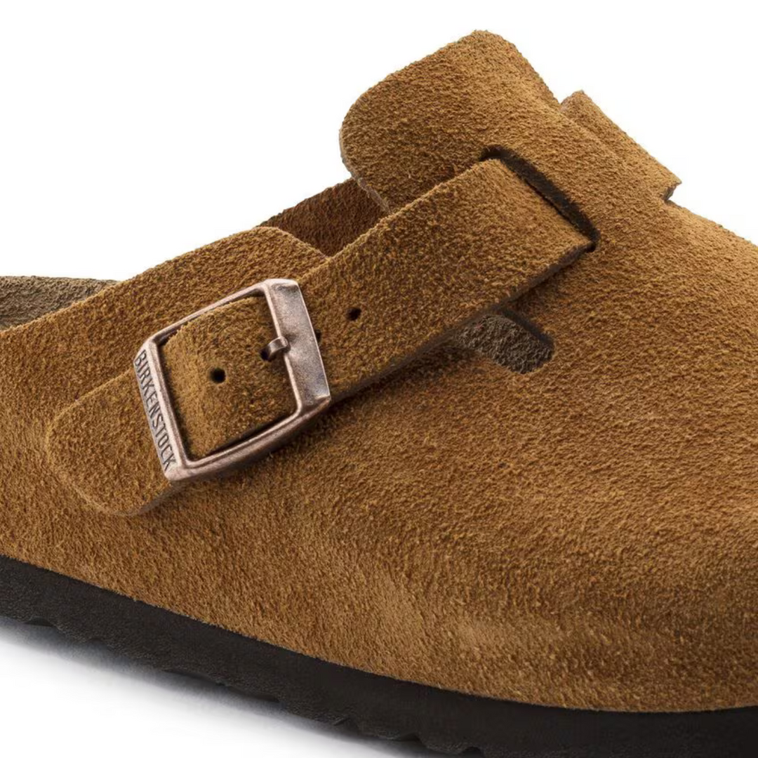 Close-up of taupe women's classic clogs, highlighting the soft cushioned footbed texture.