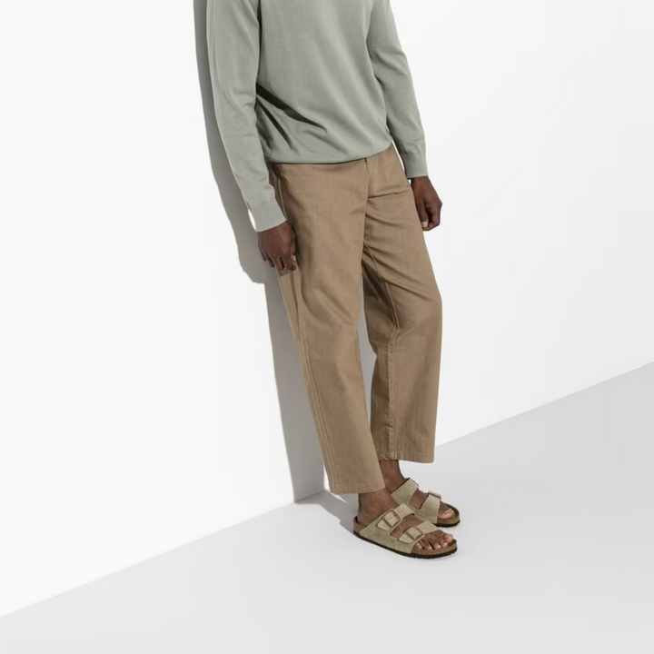 Slip-on taupe women's sandals with adjustable straps & ergonomic design, perfect for casual summer comfort.