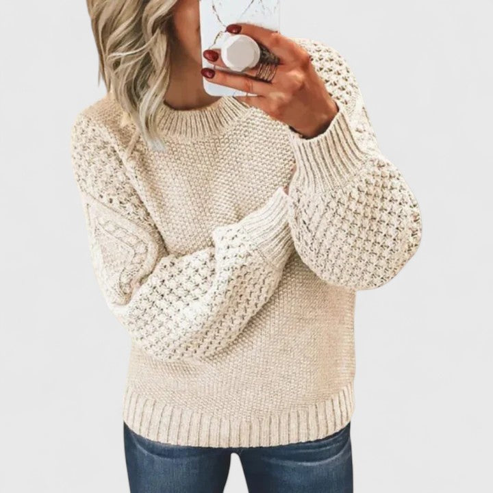 Full-length shot of a woman wearing a chic textured puff sleeve sweater with a mock neck. Ideal for cold weather.