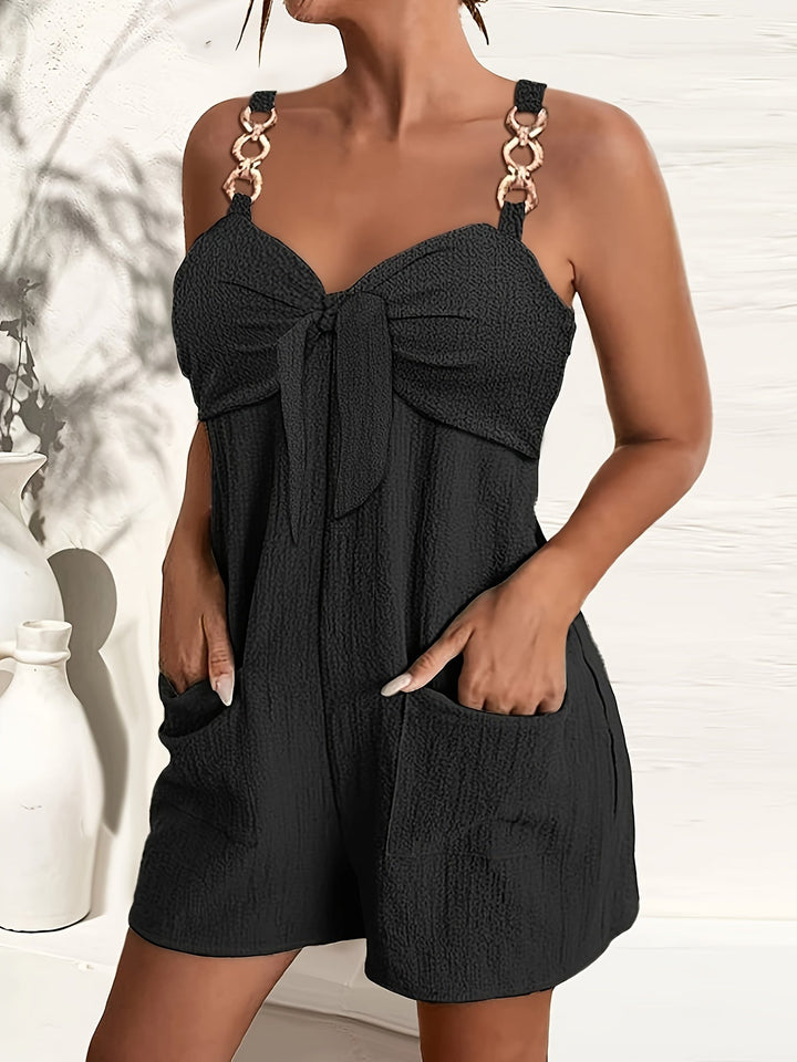 Women's textured romper with chic chain straps & sweetheart bow. Perfect for summer & vacation style.