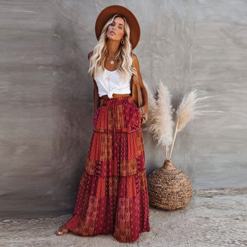 Bohemian style women's floral tiered maxi skirt, high elastic waist, flowing for casual summer wear.