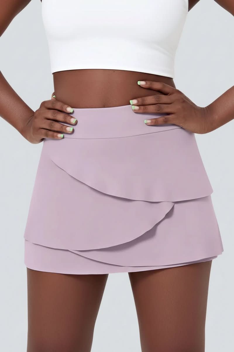 Athletic women's tiered golf skort, high-performance activewear with built-in shorts and stylish design.