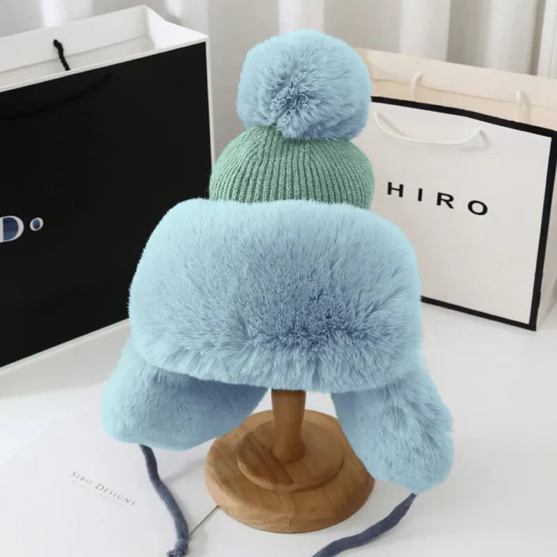 Plush women's earflap winter hat. Offering cozy warmth for snow, skiing & cold outdoor adventures.