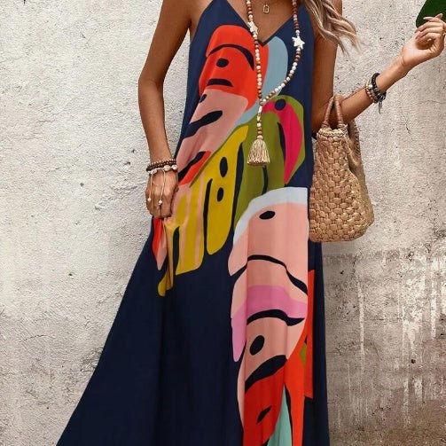 Flowy women's tropical leaf print long maxi dress. Sleeveless boho chic resort wear for summer vacations.