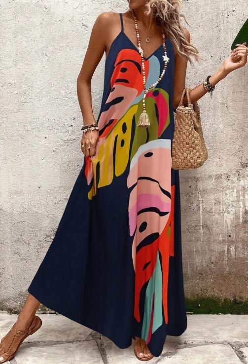 Elegant women's sleeveless tropical maxi dress with a vibrant leaf print. Ideal casual resort & vacation wear.