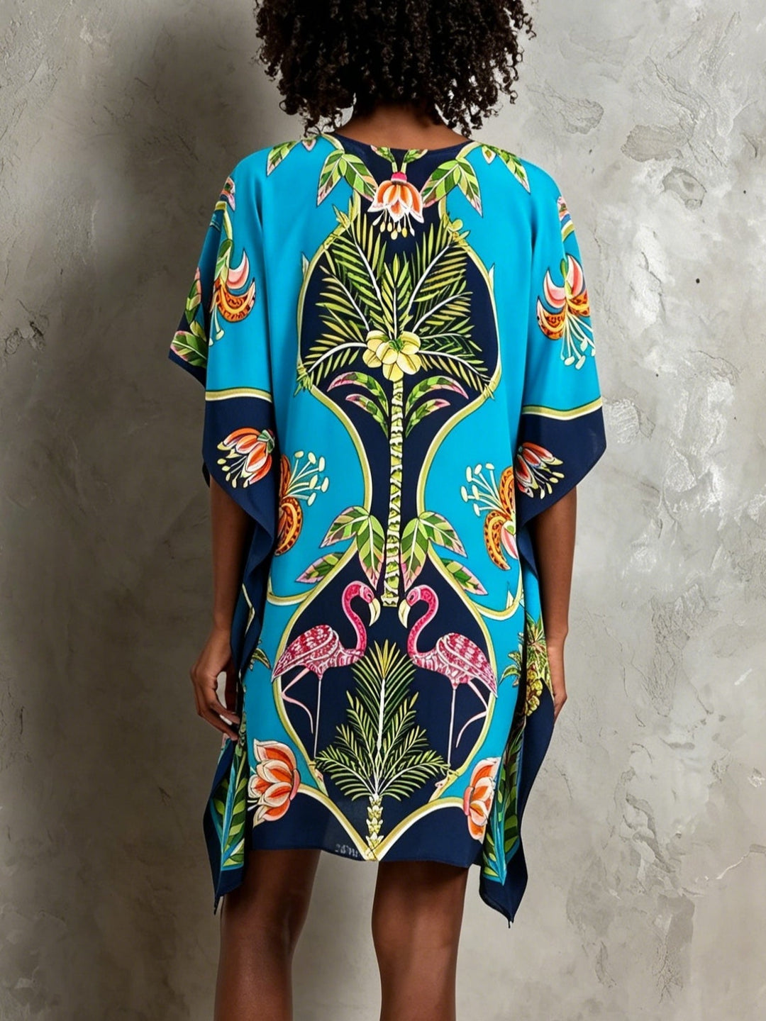 Flowing women's tropical midi kaftan dress with V-neck & batwing sleeves, ideal for beach or resort.
