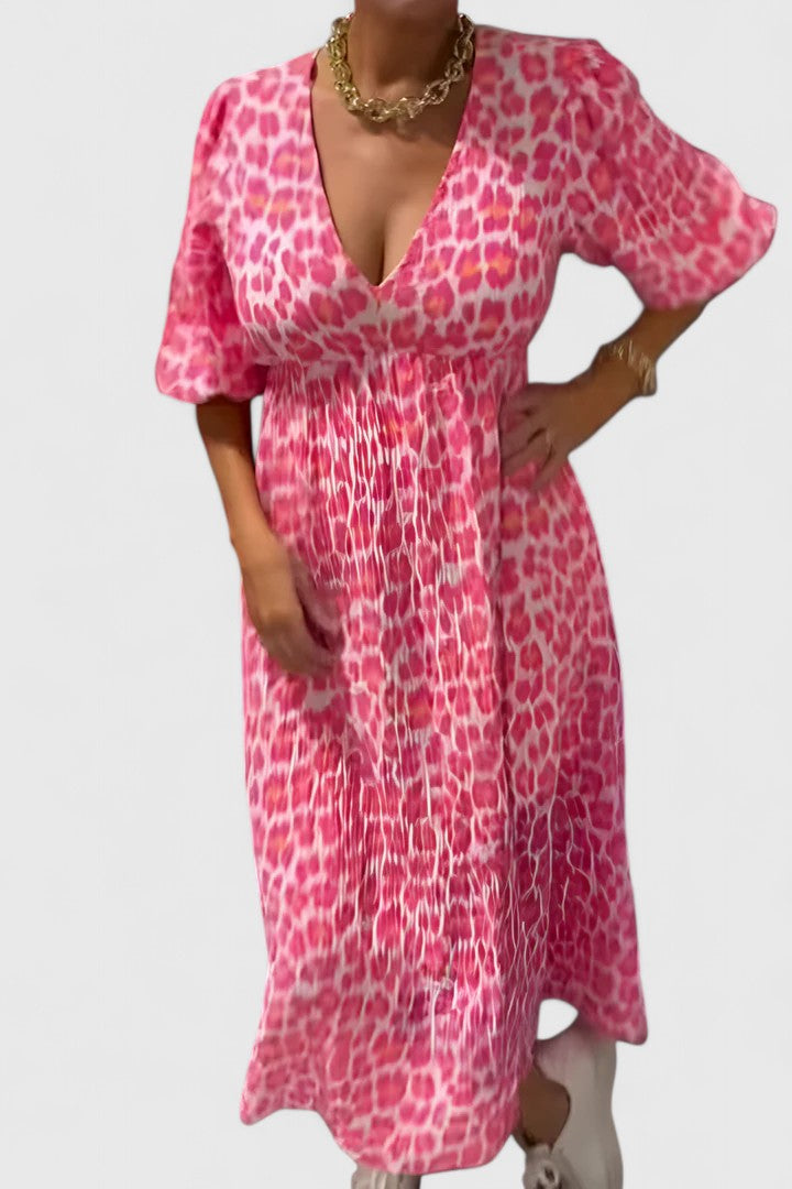 Elegant flowing tropical stripe maxi dress with puff sleeves & V-neck, perfect casual or vacation attire.