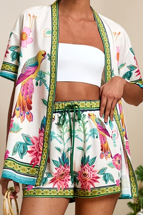 Women's tropical two-piece summer outfit set with vibrant floral print, short sleeve top & matching shorts.