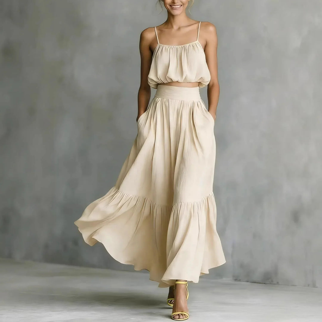 Stylish women's spaghetti strap crop top & high-waist flowy maxi skirt set with ruffle hem, ideal summer outfit.