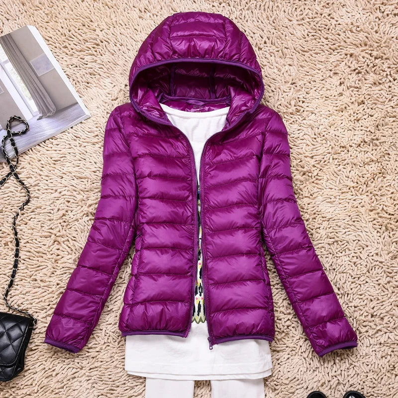 Women's packable insulated hooded jacket, essential for travel & cold weather.