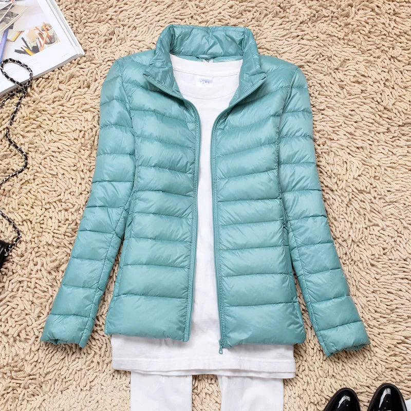 Women's insulated hooded jacket, featherlight warmth for versatile outdoor activities.