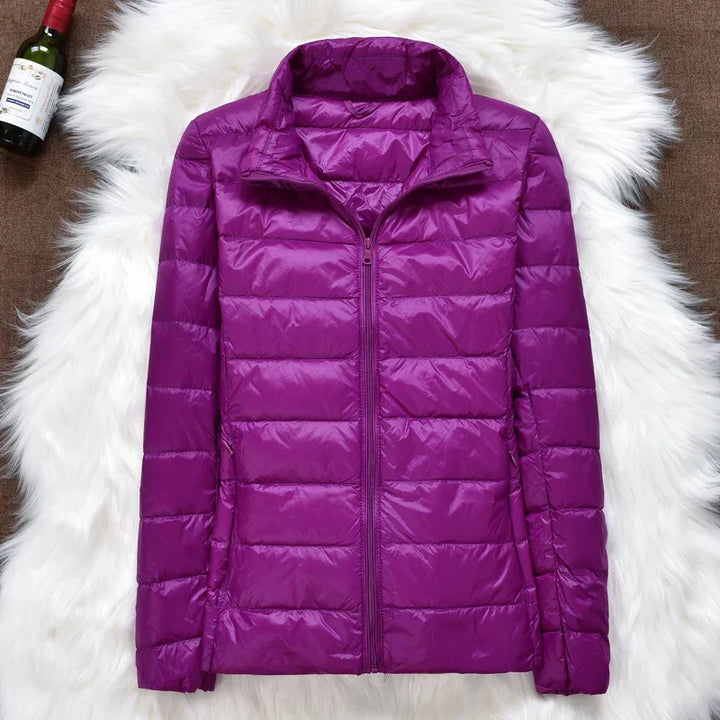 Warm women's travel coat, ultralight & packable with a cozy hood and insulation.