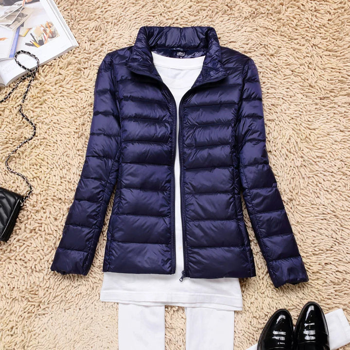 Ultralight women's hooded winter coat, offering insulated warmth & sleek design.