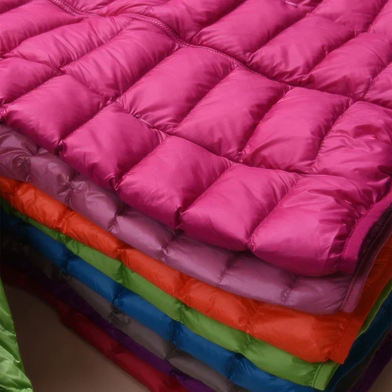 Featherlight women's insulated jacket, a stylish & warm hooded coat for cold weather.