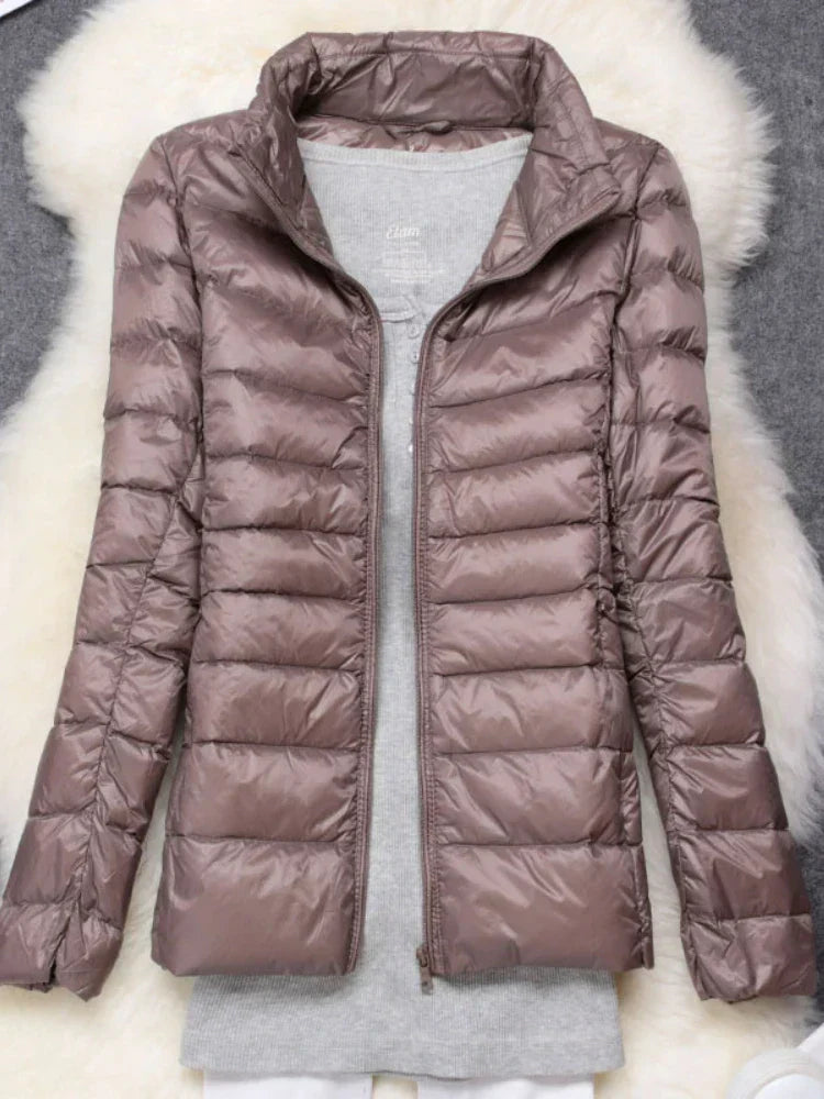 Insulated women's travel jacket, a lightweight & warm hooded coat for adventures.
