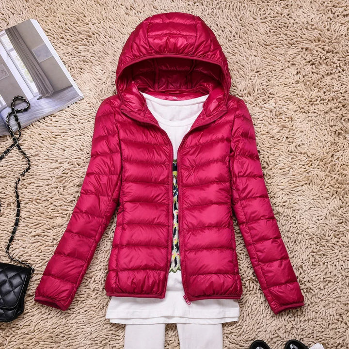 Packable women's insulated outerwear, a lightweight & warm hooded travel jacket.