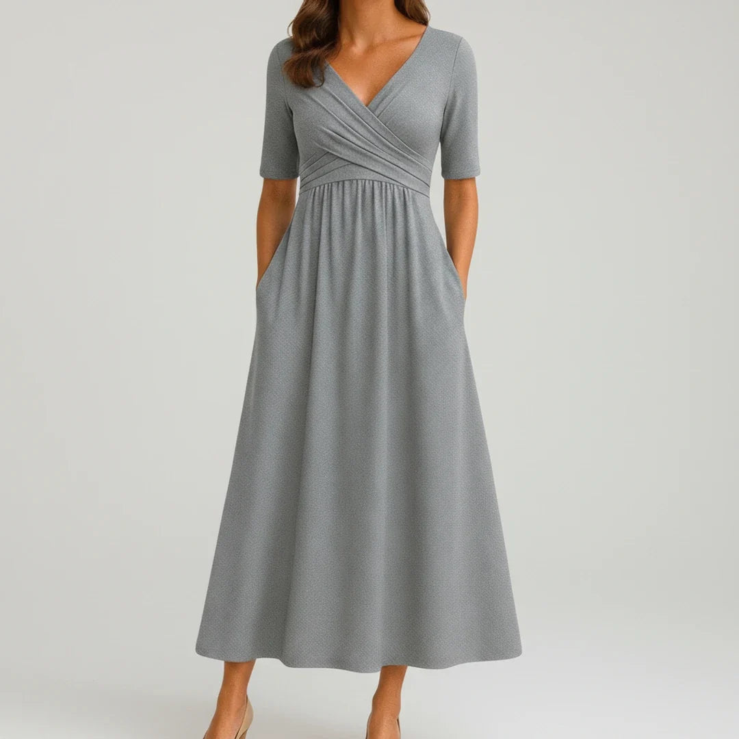 Women's V-neck A-line midi dress with convenient pockets, perfect for versatile everyday wear & spring fashion.